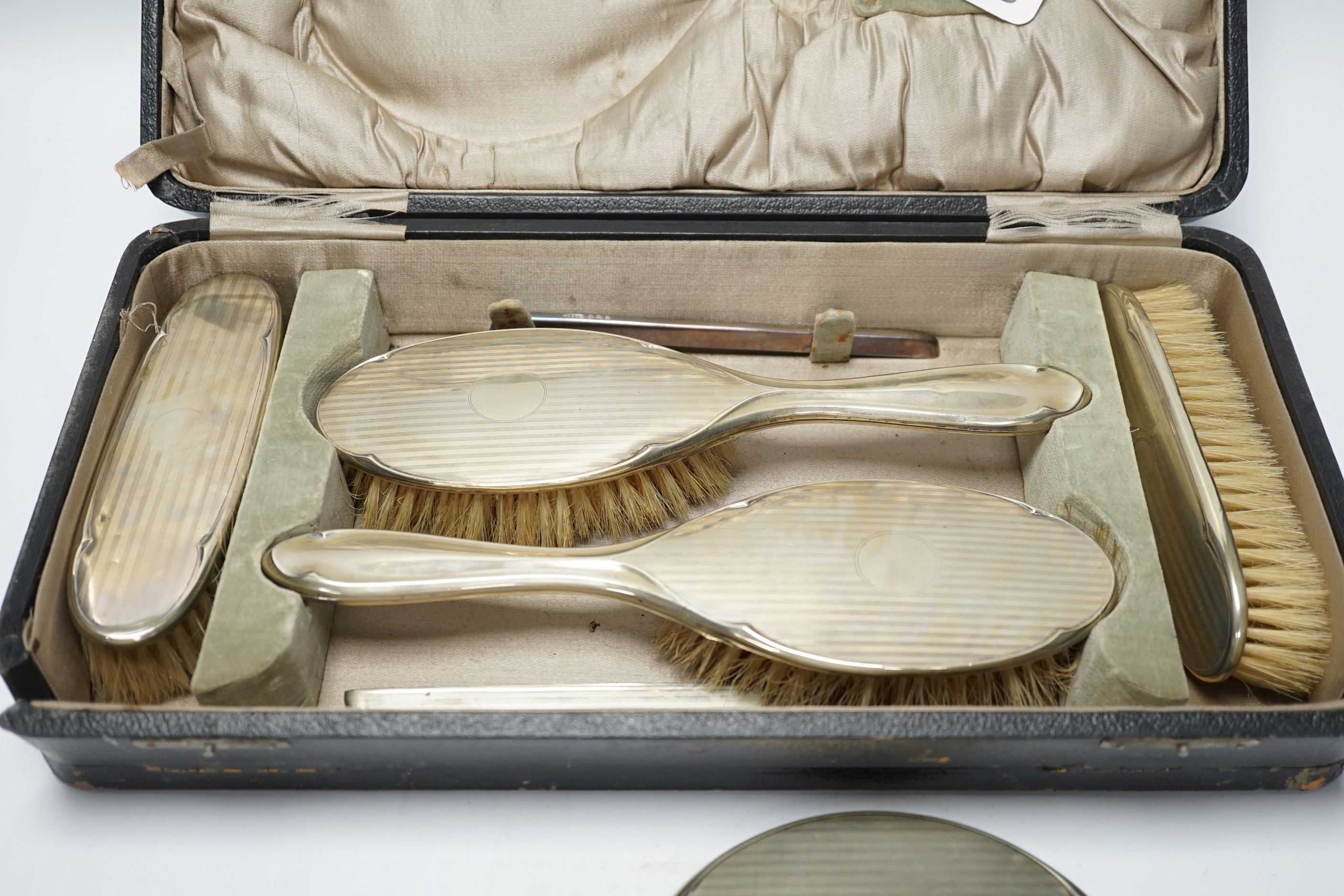 A cased 1930's six piece plated mirror and brush set.
